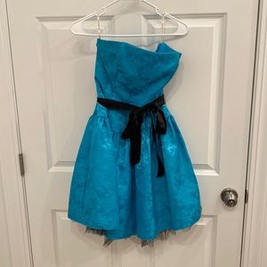 Light blue strapless semiformal dress with floral detailing and black satin belt